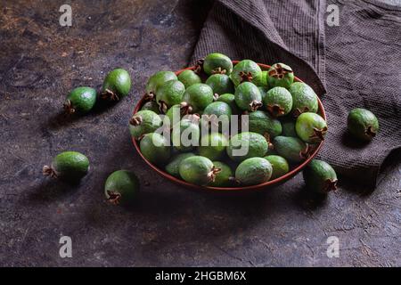 Green organic tropical feijoa fruits on a dark kitchen table. Healthy food and nutrition concept, copy space. Stock Photo