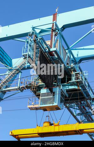 Gantry crane cabin. Steel structure in port used for lifting heavy shipping containers or crates. Dublin, Ireland Stock Photo