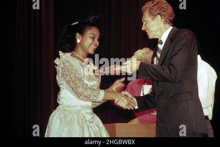 Austin,Texas USA 1990: Hispanic child gets an academic award from the head of the Austin Independent School District (AISD). Stock Photo