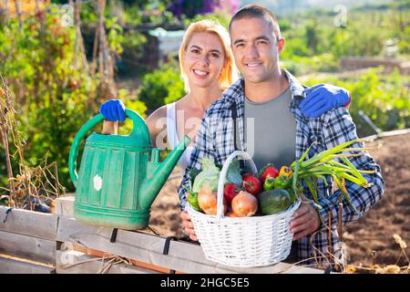 Family in garden posing with harvested vegetables Stock Photo - Alamy