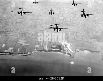 A-20 Havoc bombers from the  9th Air Force bombing Pointe du Hoc prior to the D-Day landings. The smoke can be seen rising from the fortifications on the cliffs. Omaha beach is in the middle of the photo, to the left of Pointe du Hoc Stock Photo