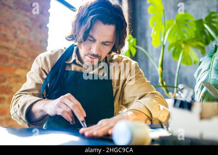 creating process of the leather things in the handmade workshop Stock Photo