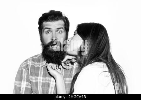 Funny couple shaving. Barbershop beard care. Bearded man getting haircut by hairdresser. Barber scissors and straight razor. Stock Photo