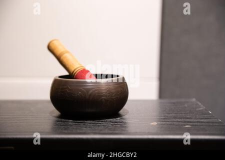 Ceramic mortar bell and wooden stick in music recording studio Stock Photo