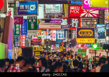 May 1, 2015: Colorful neon advertisement banners filled with the sky in the busy streets of Kowloon, hong kong, china at night. It is an iconic scener Stock Photo