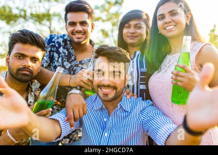 multiethnic people spending time together making selfie with lemonade Stock Photo