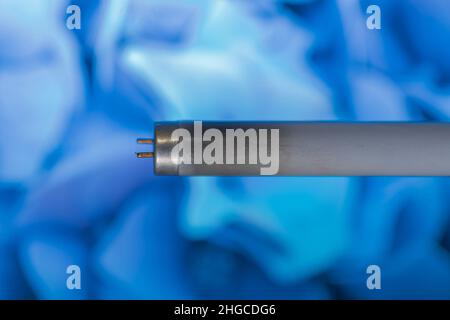 Neon or fluorescent bulb tube which is burnt or bad as it can be seen as there is black or dark part of glass near the edge of a lamp. Stock Photo