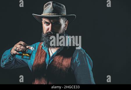 Bartender holding glass of whisky. Tasting and degustation concept. Retro vintage man with whiskey or scotch. Bartender leather apron holding whisky Stock Photo