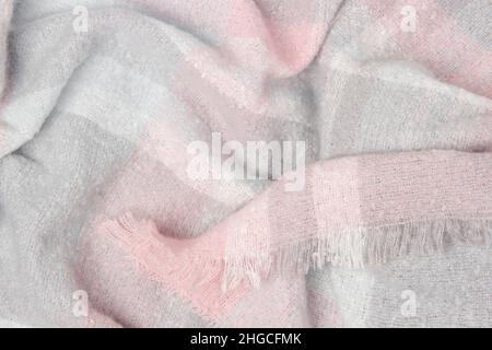 Warm woolen plaid close-up. Abstract textile background or texture. Winter cozy background for cold weather. Stock Photo