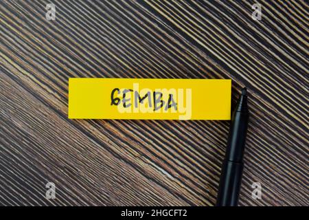 Gemba write on sticky notes isolated on Wooden Table. Stock Photo
