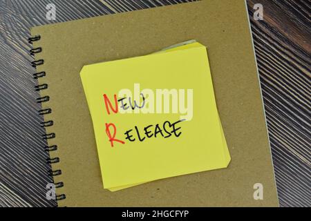 New Release write on sticky notes isolated on Wooden Table. Stock Photo