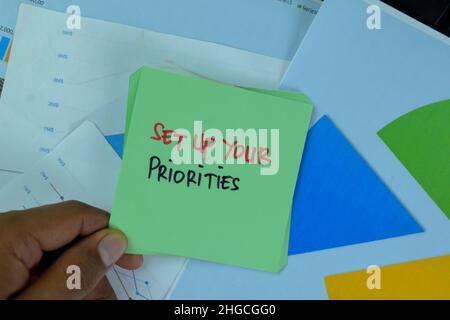 Set Up Your Priorities write on sticky notes isolated on Wooden Table. Stock Photo