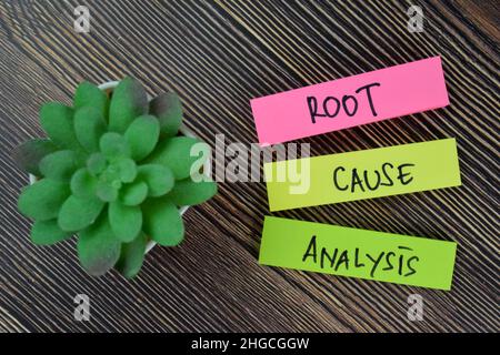 Root, Cause, Analysis write on sticky notes isolated on Wooden Table. Stock Photo
