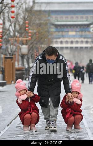 Beijing, China. 20th Jan, 2022. Twin sisters play in snow in Beijing, capital of China, Jan. 20, 2022. Credit: Li Xin/Xinhua/Alamy Live News Stock Photo