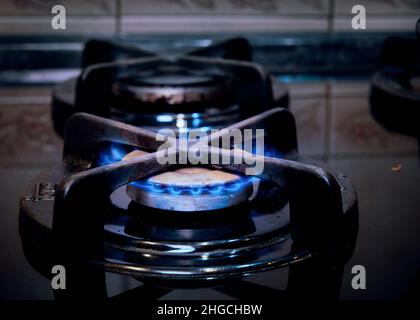 Premium Photo  Boiling water in ladle on blue flame burner steel pot on  gas burner