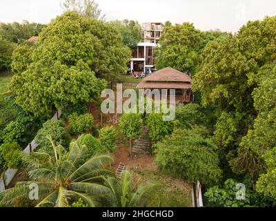 Port Dickson, Malaysia: Nov 19, 2021 - Aerial view of a bungalow with private swimming pool surrounded with trees. Stock Photo