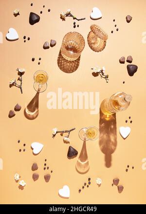 Creative pattern of bottles, cups, flowers and hearts with a round copy space in the middle. Brown background. Flat lay, top view Stock Photo