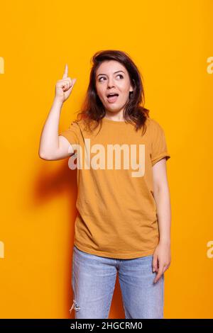 Portrait of gorgeous positive person indicate fingers empty space offer ...