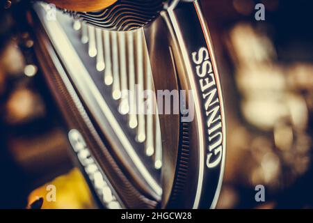 Bucharest, Romania - December 3, 2021: Illustrative editorial image of a Guinness beer tap displayed in a pub in Bucharest, Romania. Stock Photo