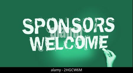 Sponsors welcome phrase handwritten on chalkboard with chalk in a hand. Business startup concept. Stock Photo