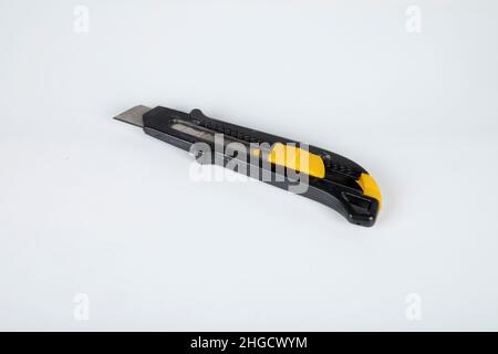 Yellow cutter knife isolated on white background Stock Photo