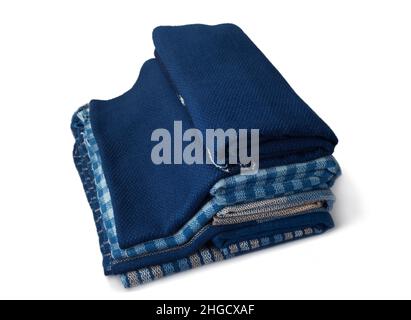 Stacks of hand woven shawls, Thai cotton indigo dyed isolated on white background Stock Photo