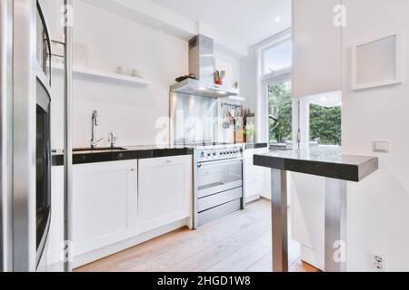 Contemporary White Kitchen with Concrete Countertop, Pull-Out Cutting Board  Stock Photo - Alamy