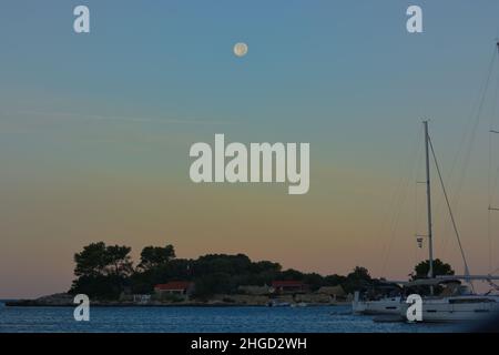 Beautiful colours of Sunset in Dalmatia, Croatia with full moon above Stock Photo