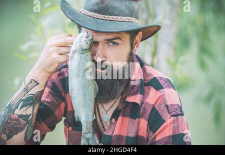 Close up bearded man catching fish. Successful catch. Big game fishing. Weekends made for fishing. Happy fly fishing. Happy fisherman near water Stock Photo