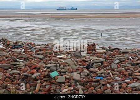 Crosby Beach on Merseyside is partly covered in tidal eroded bricks that were dumped there from ruins caused by Second World War German bombing. Stock Photo