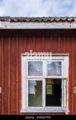 Open window on an old red cottage Stock Photo