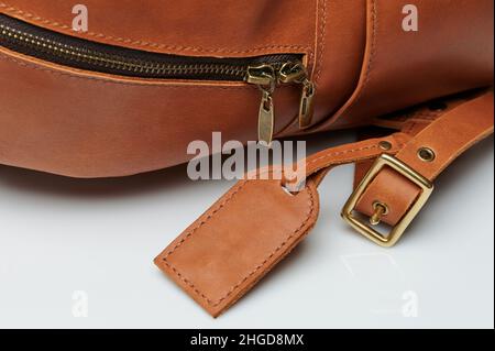 Accessories on brown leather backpack macro close up view Stock Photo