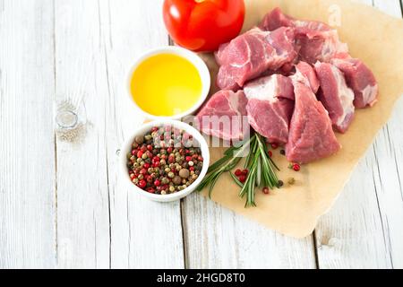 raw pork neck meat cut in pieces on wooden table Stock Photo
