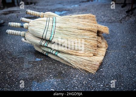 Old brooms on a street in outdoor market, close up, outdoor photography Stock Photo