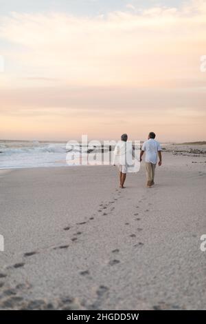 couple leaving footprints in the sand at the beach Stock Photo - Alamy