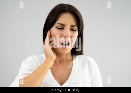 Earache And Pain. Unhappy Woman With Otitis Externa Stock Photo