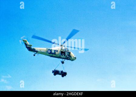 Royal Navy Wessex 2  helicopter off loading vehicles from HMS Bulwark during Aden withdrawall 1967 Stock Photo