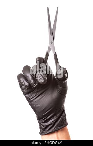 Hairdressers hand in black rubber glove holds a scissors. Isolated on white background, close-up Stock Photo