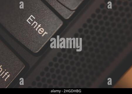 Close up shot of the enter key on a laptop computer keyboard Stock Photo