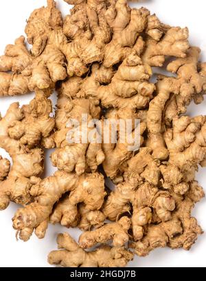 pile of freshly harvested ginger, flavoring and herbal ingredient isolated on white background, closeup view taken from above Stock Photo