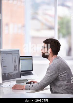 Browsing for inspiration. A young designer surfing the net for inspiration. Stock Photo