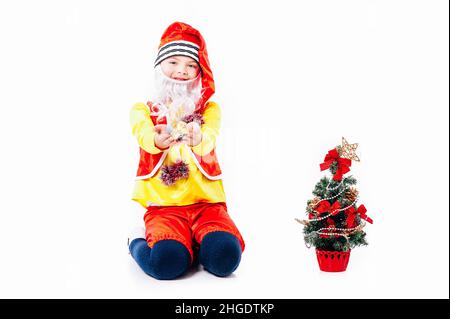 A baby dressed as a elf. isolated. Santa's helper. boy in suit of dwarf or elf Stock Photo