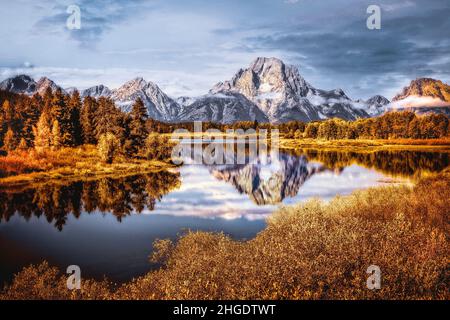 Mount Moran reflects in the still waters of the Snake River at Oxbow Bend. Grand Tetons, Wyoming. Stock Photo