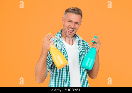 Remove dirt and grease. Cleaning day. Man cleaning. Cleaning tips to disinfect home during quarantine. Clean exterior windows. Man hold mist sprayers Stock Photo