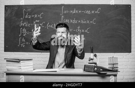 Get out of class. School principal threatening with punishment. Teacher strict serious bearded man chalkboard background. Teacher looks threatening Stock Photo