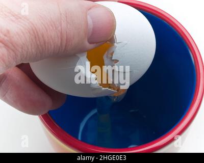 Hand cracking an egg Stock Photo