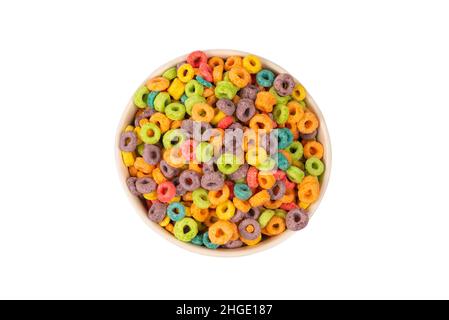 Colorful rings cereal spill out into a bowl. Breakfast. Isolated on a white background. Stock Photo