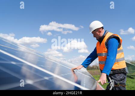 Solar power plant engineer makes a visual inspection of solar panels ...