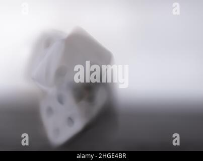 Blurry rolling dice on black and white background Stock Photo