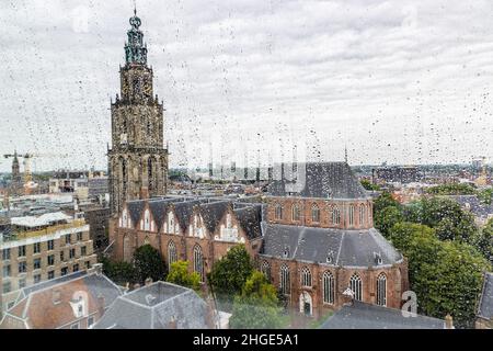 Scenic view of Martini church from through windows with raindrops of Forum building in the center of city of Groningen in The Netherlands Stock Photo